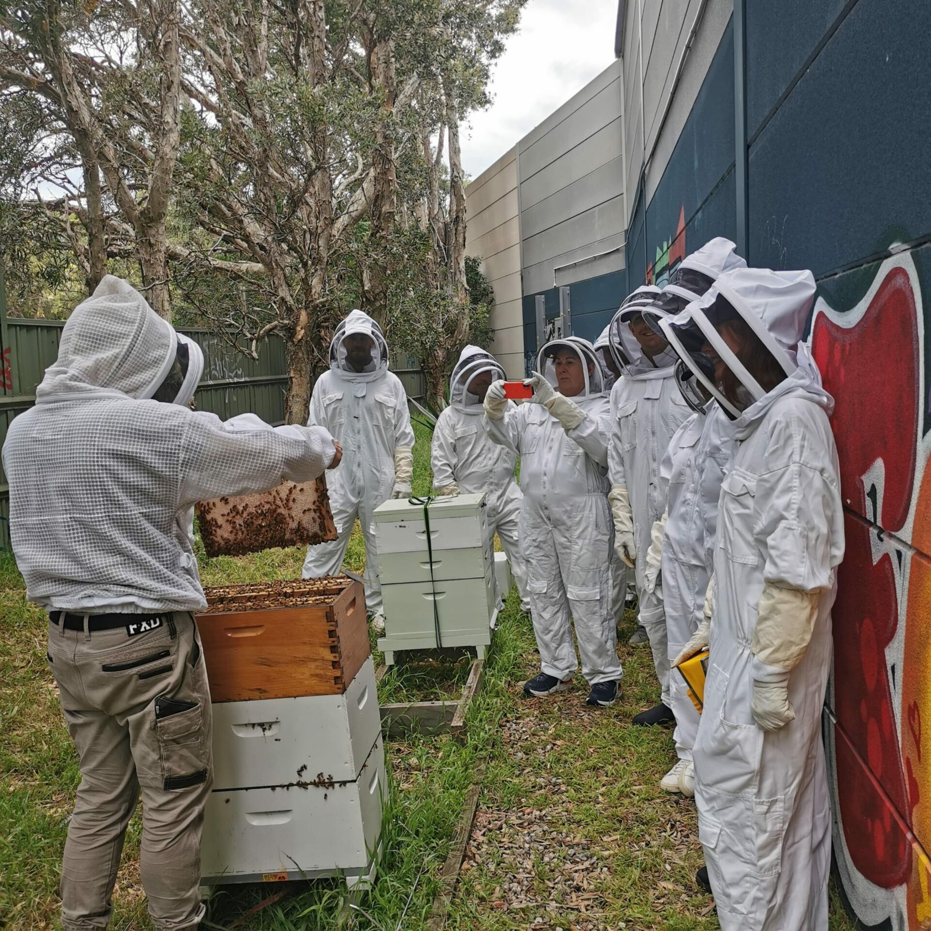 Beekeeper Doug Purdie teaches a group of apiary students on an Urban Beehive beekeeping course in Sydney